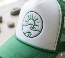 Load image into Gallery viewer, Green and white cap with a logo on a wooden surface